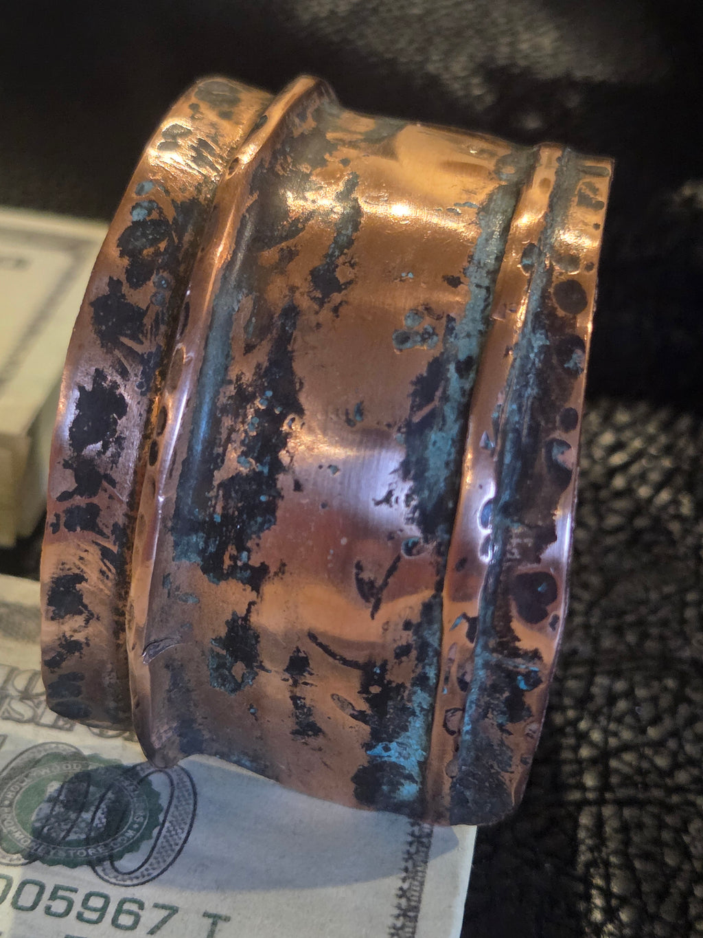 Copper bracelet on a surface with a blurred background
